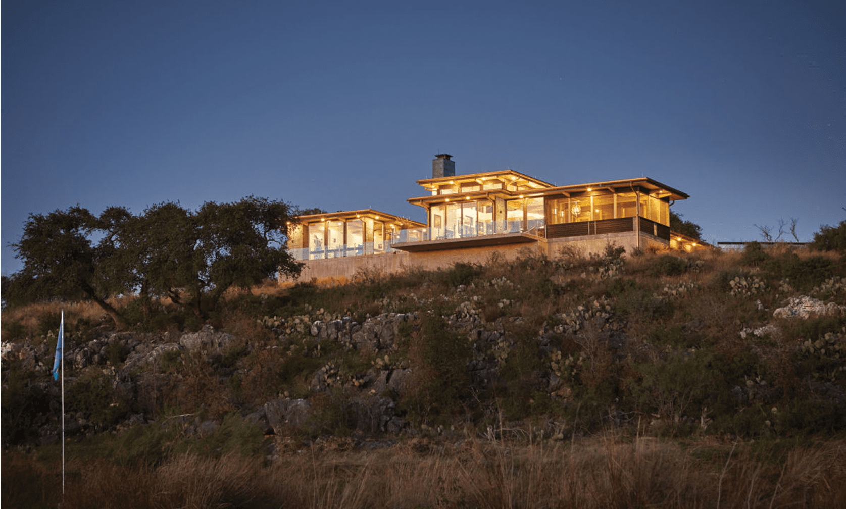 Modern house on a hill at dusk.