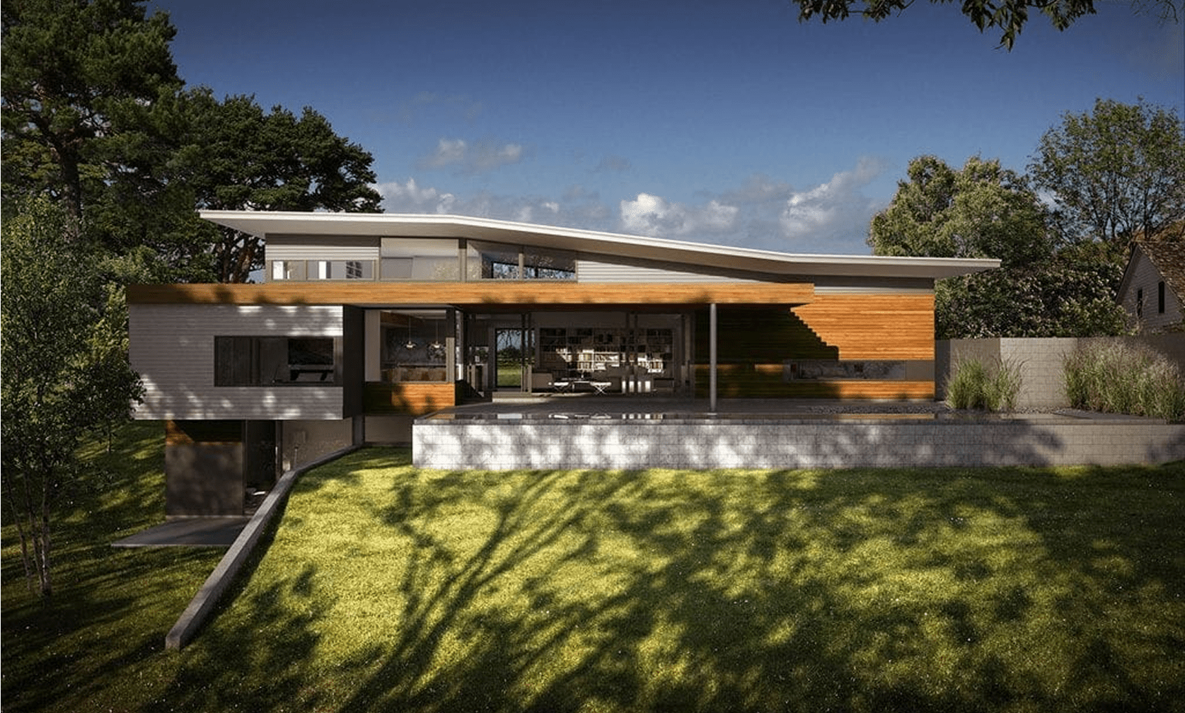 Modern house with large windows and lawn.