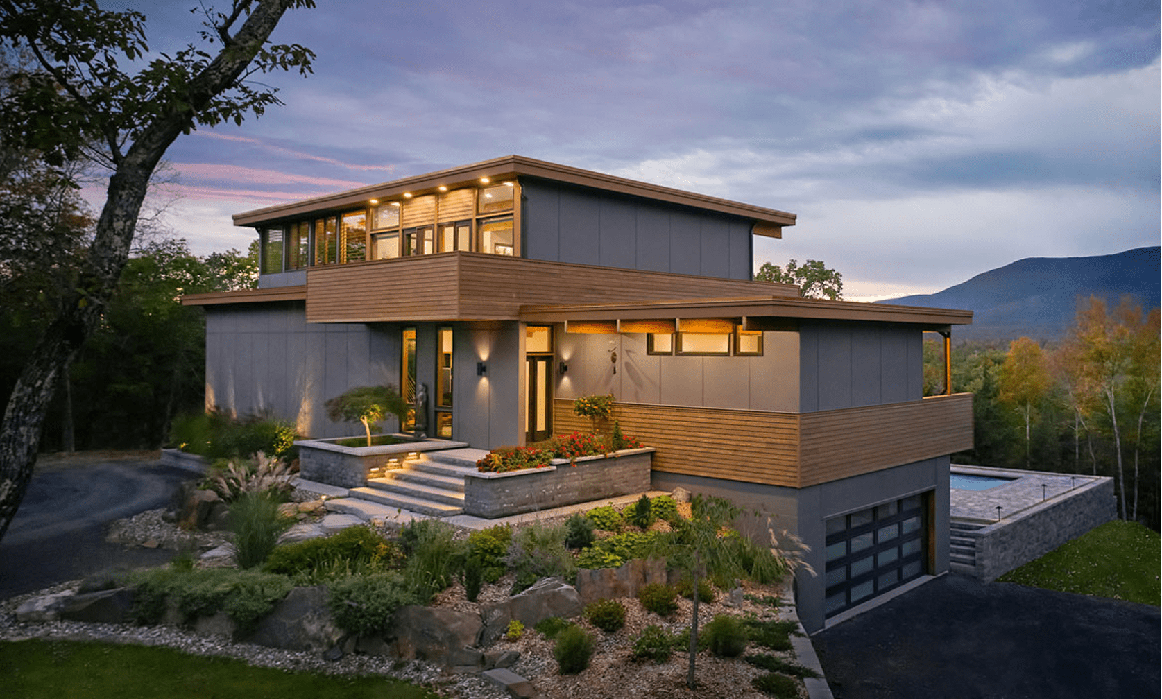Modern house with large windows, evening view.