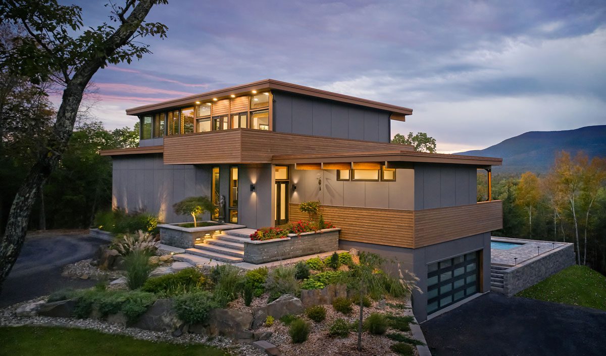 Modern house with evening lighting and landscape.