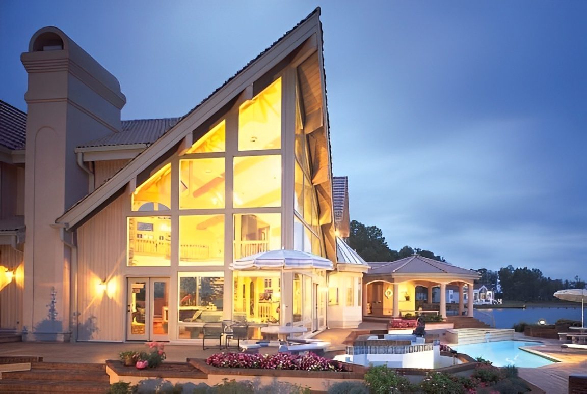 Classic-1 (2) Modern house exterior with large windows, pool.