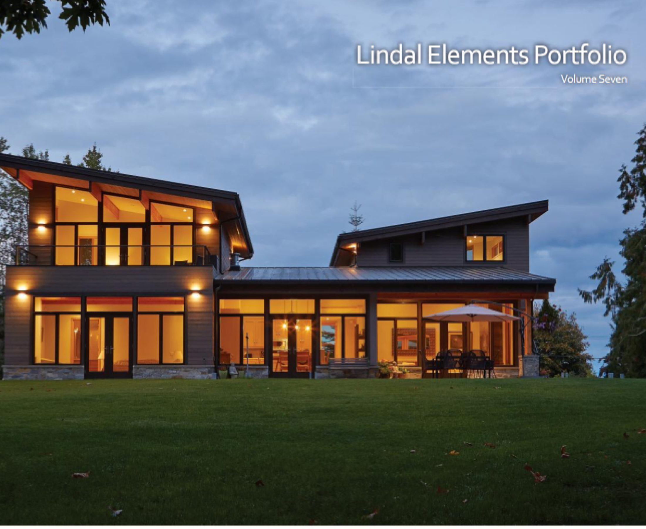 Modern house with illuminated windows at dusk.