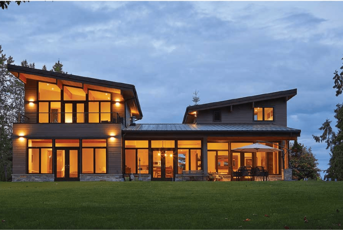 Frame 2095584745 Modern house with large windows at dusk.