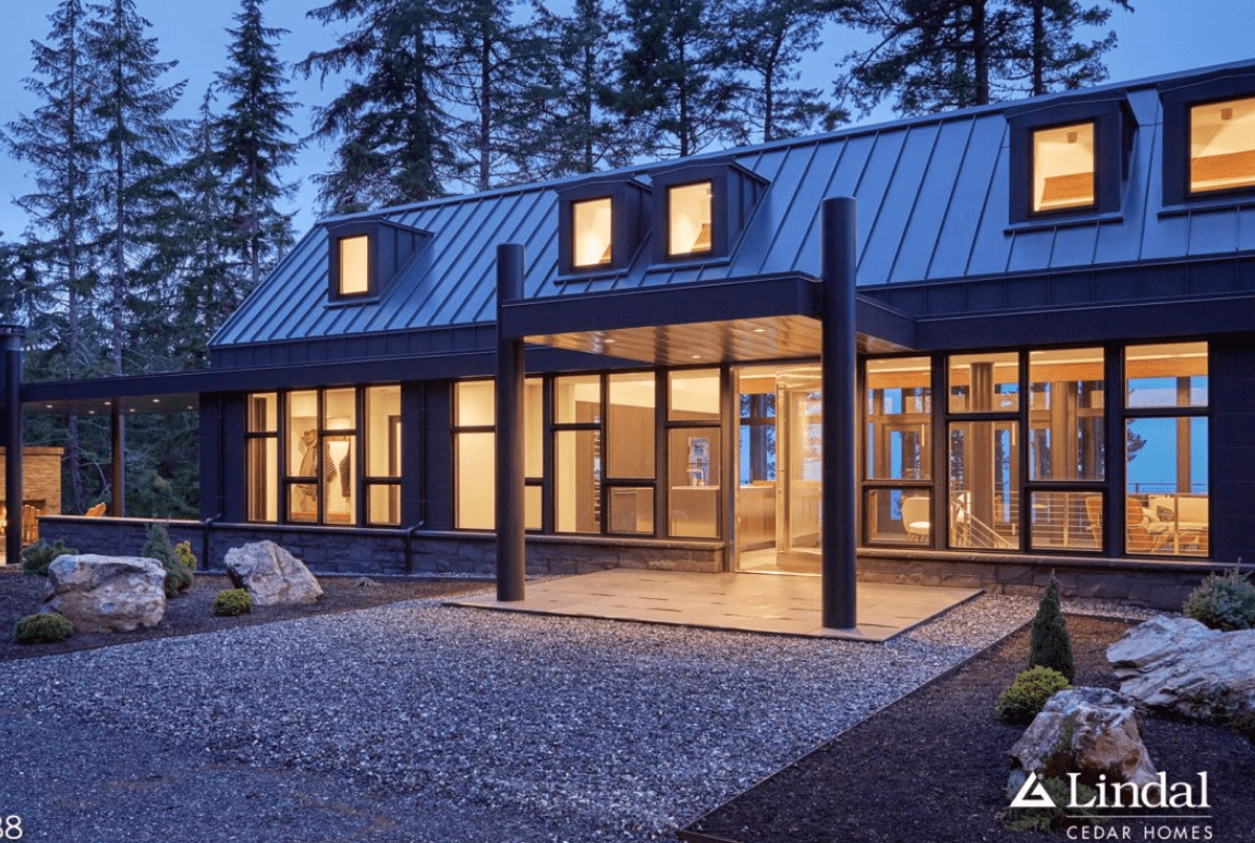 Modern house with large windows at dusk.