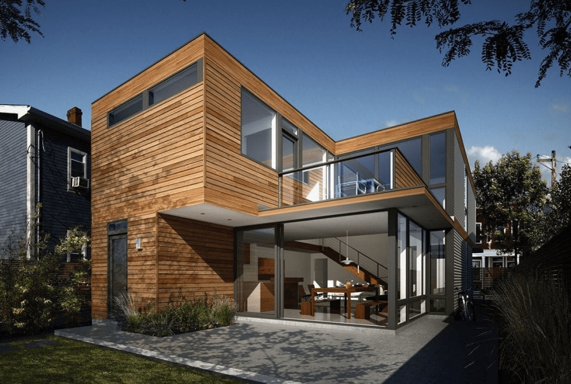 Modern wooden house with large glass windows.